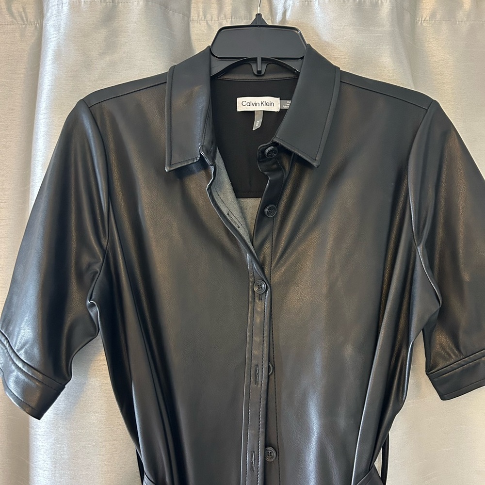 Sexy sleek black faux leather dress. Button down front with short sleeves.